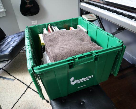 Packed bin with piano in background