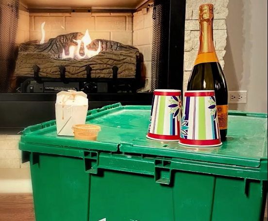 Fireplace, champagne, and a plastic moving bin
