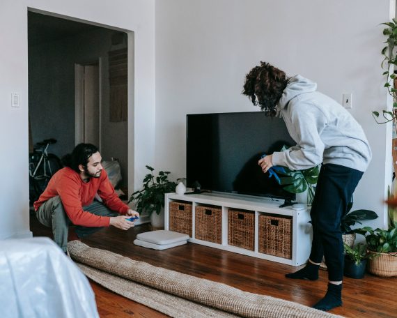Guys trying to figure out how to pack a TV